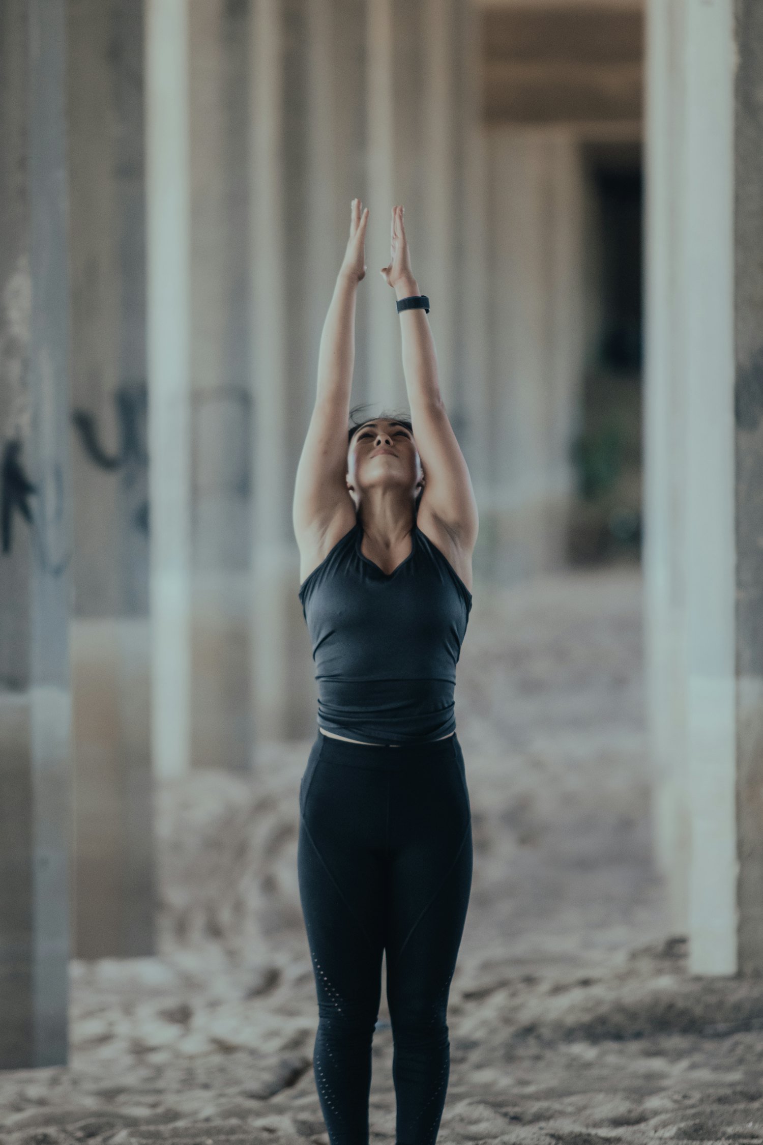 Someone stretching outdoors, a watch on their wrist.