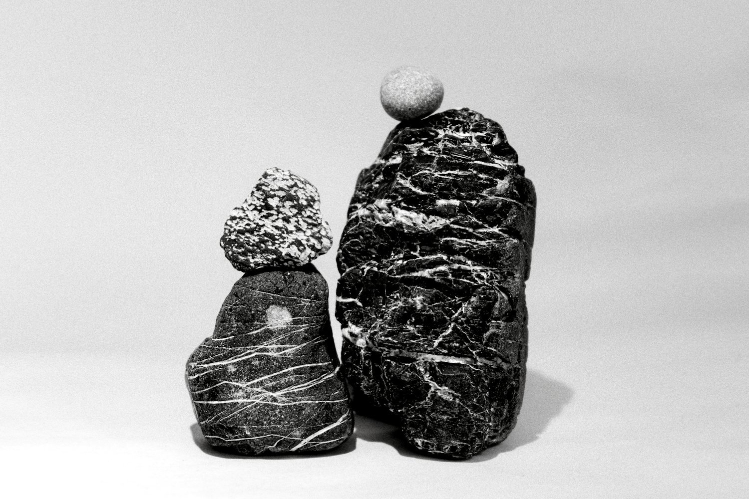 Two stacks of stones, each balanced on its own footing.